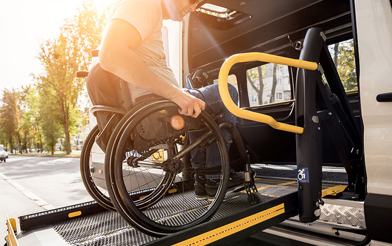 accessibleGO - man in wheelchair wheeling up into van