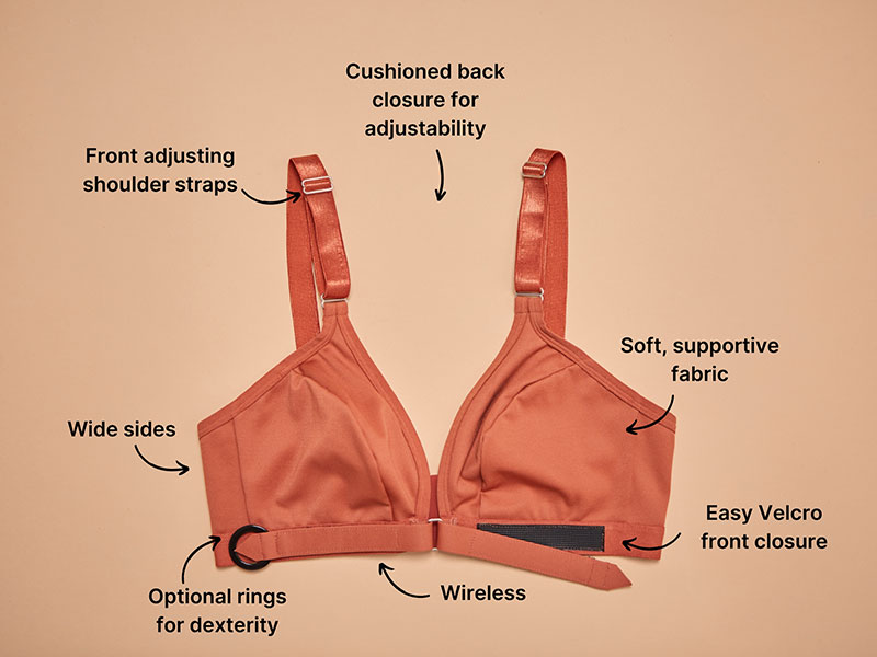 A rust-colored Springrose Easy-On Mobility Bra has the accessibility features labeled: Cushioned back closure for adjustability, Front adjusting shoulder straps, Wide sides, Soft, supportive fabric, Optional rings for dexterity, Easy EasyVelcro Velcro front closure, Wireless.